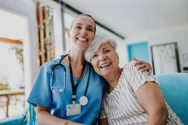 home care healthcare professional hugging senior patient